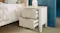 Bedside table with open drawers and ribbed ceramic lamp Bedside table with open drawers and ribbed ceramic lamp
