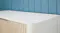 Corner view of the table with a white top and smooth edges Corner view of the table with a white top and smooth edges