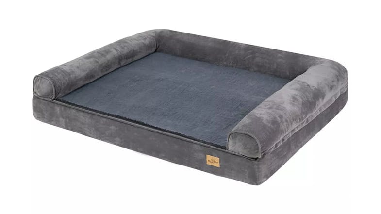 A full view of a large, rectangular, grey pet bed with plush bolsters on three sides A full view of a large, rectangular, grey pet bed with plush bolsters on three sides