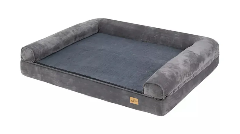 A full view of a large, rectangular, grey pet bed with plush bolsters on three sides A full view of a large, rectangular, grey pet bed with plush bolsters on three sides