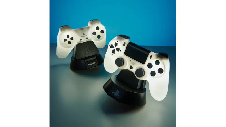 Two illuminated PS4 Controller Icon Lights glowing white, each on a black PlayStation-branded stand Two illuminated PS4 Controller Icon Lights glowing white, each on a black PlayStation-branded stand
