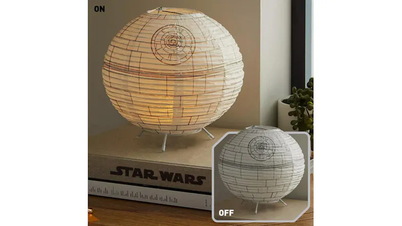Death Star LED Paper Lantern displayed on a tabletop with a warm glow and features printed Death Star design lines Death Star LED Paper Lantern displayed on a tabletop with a warm glow and features printed Death Star design lines