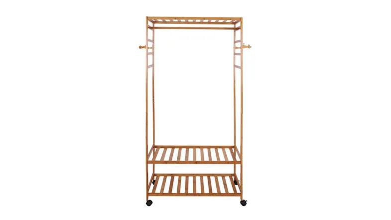 Large bamboo clothing rack with two shelves and side hooks on wheels for easy storage and mobility Large bamboo clothing rack with two shelves and side hooks on wheels for easy storage and mobility