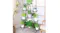 Indoor setting with a 9-tier plant stand decorated with lush green plants and flowers Indoor setting with a 9-tier plant stand decorated with lush green plants and flowers