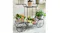 Plant stand indoors on a carpet, filled with assorted flowering plants and greenery in decorative pots Plant stand indoors on a carpet, filled with assorted flowering plants and greenery in decorative pots