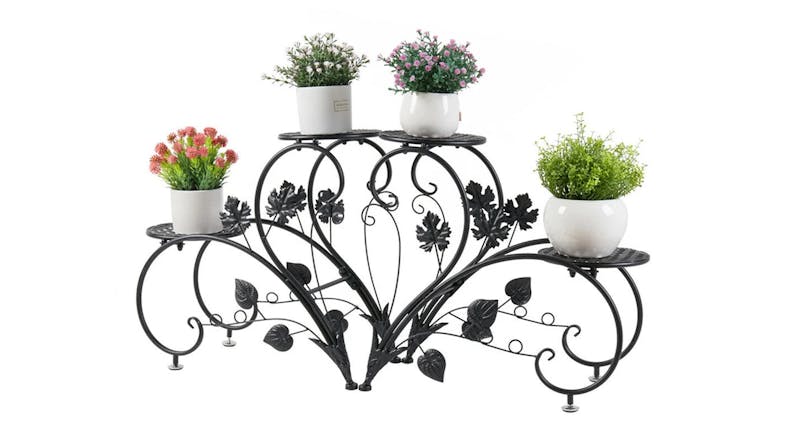 Black metal plant stand display with four tiers holding potted flowers Black metal plant stand display with four tiers holding potted flowers