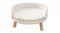 Close-up view of the round, fluffy white elevated pet bed with natural wood legs Close-up view of the round, fluffy white elevated pet bed with natural wood legs
