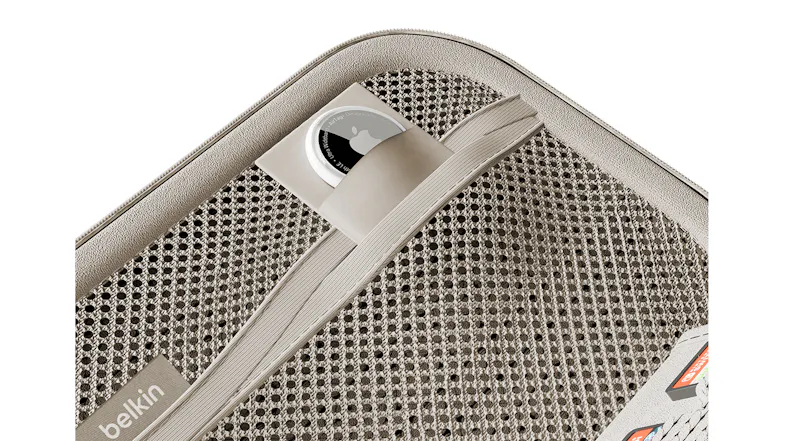 Close-up view of a case with a strap holding an Apple AirTag Close-up view of a case with a strap holding an Apple AirTag