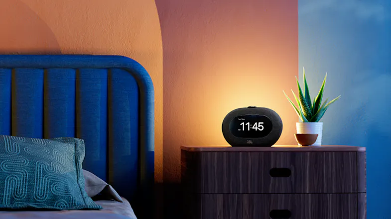 JBL Horizon 3 Bluetooth speaker on a wooden bedside table displaying time 11:45 AM JBL Horizon 3 Bluetooth speaker on a wooden bedside table displaying time 11:45 AM