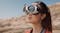 A close up view of a women wearing the vision goggles while glancing at the desert A close up view of a women wearing the vision goggles while glancing at the desert