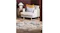 Lifestyle image of a rug in a modern living room placed under a light armchair with mustard and grey cushions Lifestyle image of a rug in a modern living room placed under a light armchair with mustard and grey cushions