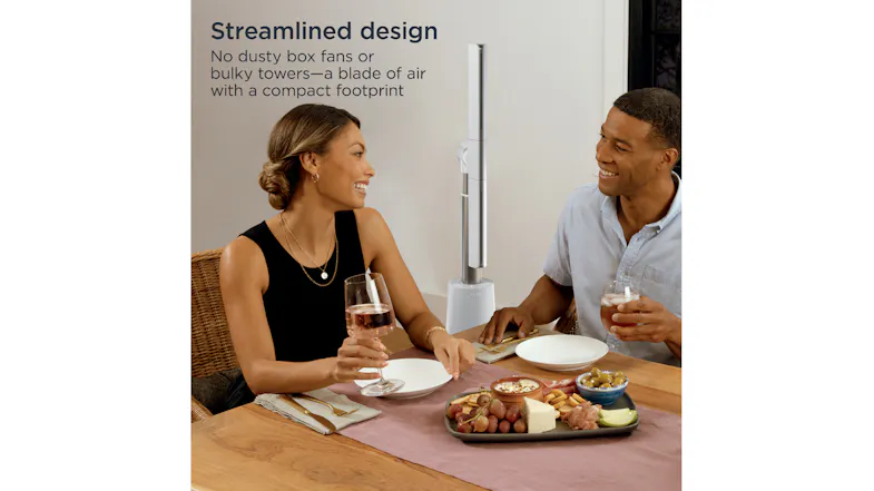 Streamlined design of the bladeless fan cooling a couple enjoying a meal indoors Streamlined design of the bladeless fan cooling a couple enjoying a meal indoors