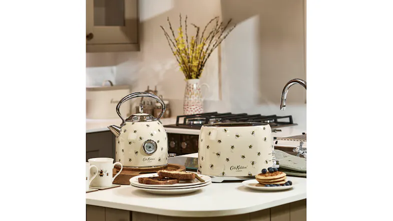 Matching Cath Kidston Bee Toaster and Kettle set on a kitchen counter with breakfast items Matching Cath Kidston Bee Toaster and Kettle set on a kitchen counter with breakfast items