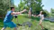 Group of friends playing BashNet outdoors on a grassy field Group of friends playing BashNet outdoors on a grassy field