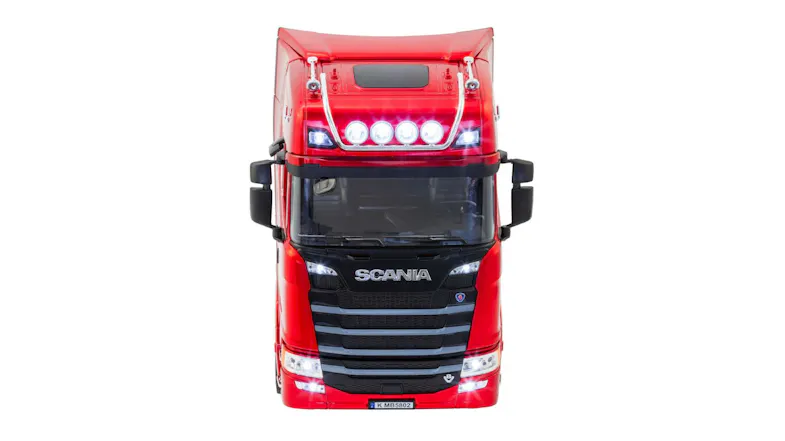 Front view of a red Scania RC truck with illuminated headlights and roof lights Front view of a red Scania RC truck with illuminated headlights and roof lights