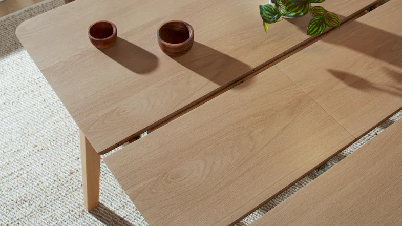Table extended with an additional leaf in place, creating a larger dining surface Table extended with an additional leaf in place, creating a larger dining surface