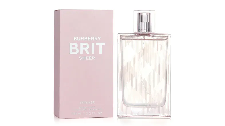 Burberry Brit Sheer perfume bottle beside a pink box with silver text Burberry Brit Sheer perfume bottle beside a pink box with silver text