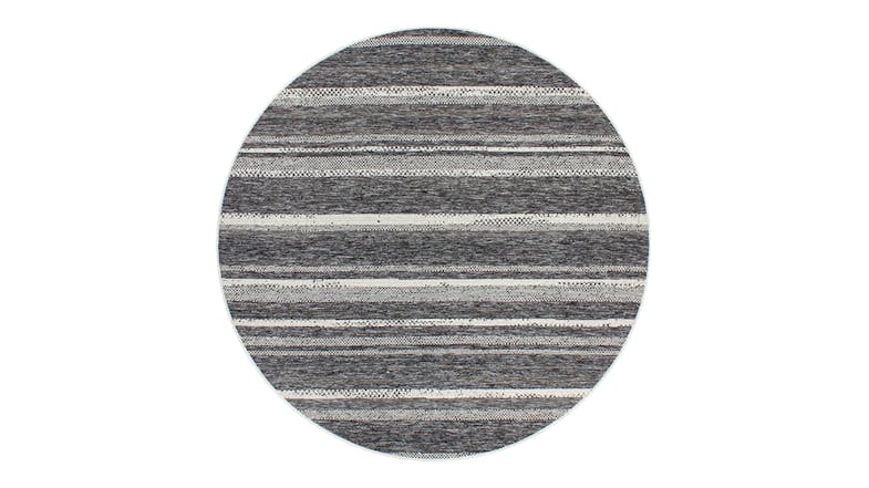 A circular view of the St Ives Outdoor Rug featuring horizontal, multi-tonal charcoal stripes A circular view of the St Ives Outdoor Rug featuring horizontal, multi-tonal charcoal stripes