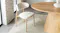 Single Ryder dining chair with stylish legs placed beside a round dining table Single Ryder dining chair with stylish legs placed beside a round dining table