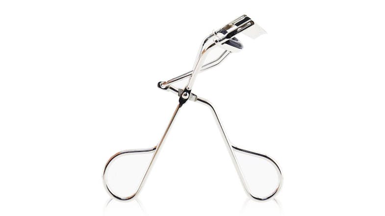 A close-up image of the Shu Uemura eyelash curler shown standing upright A close-up image of the Shu Uemura eyelash curler shown standing upright