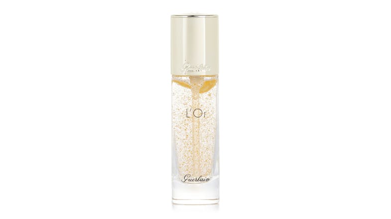 A front view of the Guerlain L'Or Radiance Primer features pure gold flakes in a clear bottle topped with a gold cap A front view of the Guerlain L'Or Radiance Primer features pure gold flakes in a clear bottle topped with a gold cap