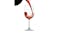 Red wine splashing into a tall-stemmed glass Red wine splashing into a tall-stemmed glass