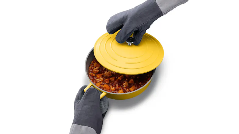 Padded glove holding a yellow cooking pot and the lid Padded glove holding a yellow cooking pot and the lid