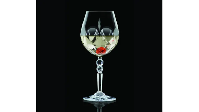A close-up view of a crystal wine glass with a red cocktail A close-up view of a crystal wine glass with a red cocktail