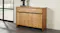 Raglan Buffet Table with a natural wood finish and bold grain patterns, featuring two doors and a drawer Raglan Buffet Table with a natural wood finish and bold grain patterns, featuring two doors and a drawer