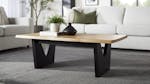 Raglan Coffee Table with a natural wood top and black V‑shaped legs, shown in a living room setting Raglan Coffee Table with a natural wood top and black V‑shaped legs, shown in a living room setting