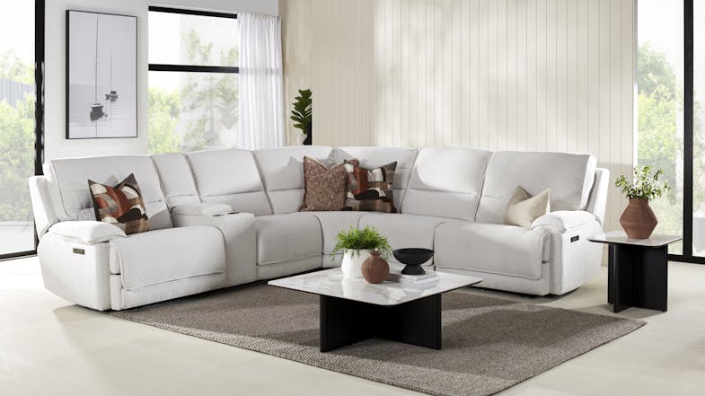 A large marshmallow-coloured L-shaped sectional sofa with multiple reclining seats and plush cushions A large marshmallow-coloured L-shaped sectional sofa with multiple reclining seats and plush cushions