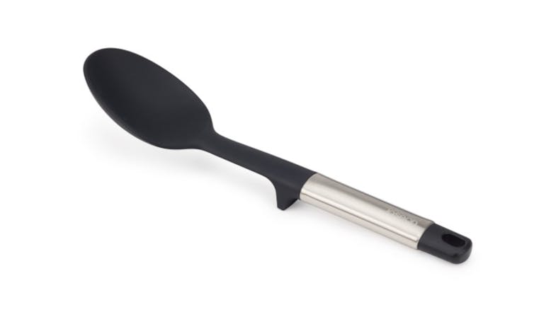 A Joseph Joseph Elevate Solid Spoon featuring a black silicone head, a stainless steel handle, and a hanging hole A Joseph Joseph Elevate Solid Spoon featuring a black silicone head, a stainless steel handle, and a hanging hole