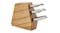 Wooden knife block holding three stainless steel knives with curved handles Wooden knife block holding three stainless steel knives with curved handles