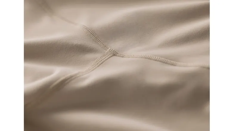 Close-up view of a beige fabric with a reinforced stitch Close-up view of a beige fabric with a reinforced stitch