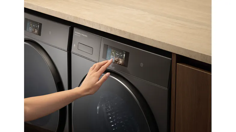 A hand setting the dryer's cycle A hand setting the dryer's cycle