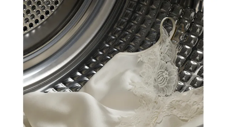 A close up view of a cream clothing being dried inside the unit A close up view of a cream clothing being dried inside the unit