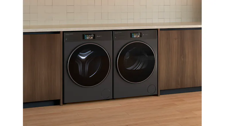 A side view of the dryer positioned beside its compatible washer in a laundry room A side view of the dryer positioned beside its compatible washer in a laundry room