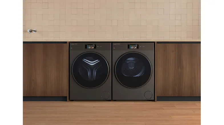 A front view of the dryer positioned beside its compatible washer in a laundry room A front view of the dryer positioned beside its compatible washer in a laundry room