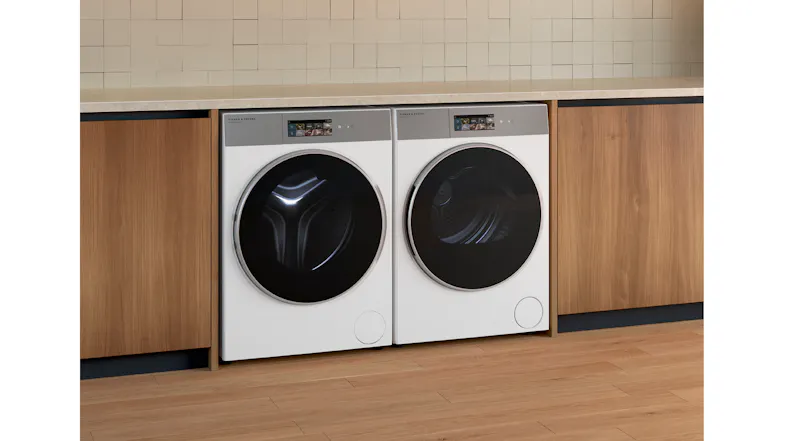 A side view of the dryer positioned beside its compatible washer in a laundry room A side view of the dryer positioned beside its compatible washer in a laundry room