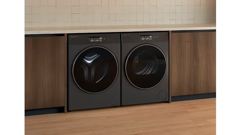 A side view of the dryer positioned beside its compatible washer in a laundry room A side view of the dryer positioned beside its compatible washer in a laundry room