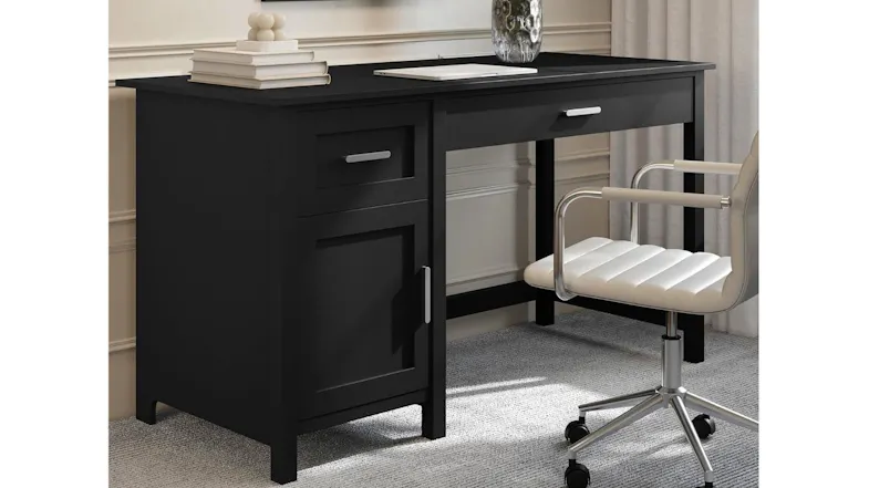 An office desk with a cabinet and two drawers, placed in a modern room with books on top An office desk with a cabinet and two drawers, placed in a modern room with books on top
