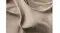 Close-up view of a beige fabric with a reinforced stitch Close-up view of a beige fabric with a reinforced stitch