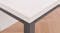 A close-up of a modern desk corner with a white tabletop and black metal legs A close-up of a modern desk corner with a white tabletop and black metal legs