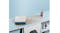 A view of the ironing mat fully set up on a countertop above a washing machine A view of the ironing mat fully set up on a countertop above a washing machine