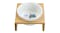 White ceramic pet bowl on a wooden stand with a printed label White ceramic pet bowl on a wooden stand with a printed label