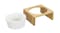 A white ceramic pet bowl next to a bamboo stand with a circular cutout for the bowl A white ceramic pet bowl next to a bamboo stand with a circular cutout for the bowl