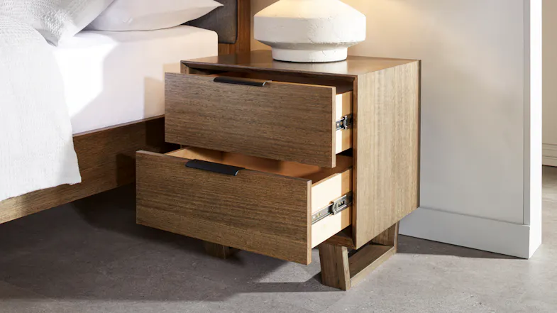 The bedside table with its drawers slightly pulled out The bedside table with its drawers slightly pulled out