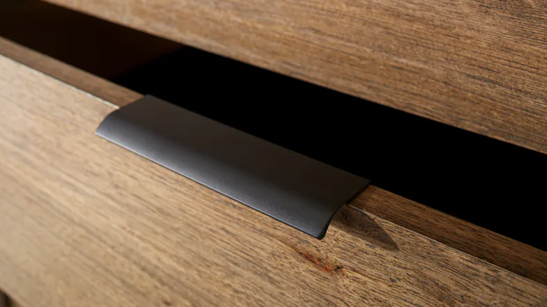 A close up view of the bedside table's drawer handle A close up view of the bedside table's drawer handle