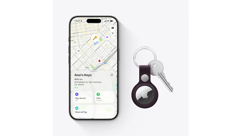 The airtag attached to a key and a smartphone with the Find My App opened The airtag attached to a key and a smartphone with the Find My App opened