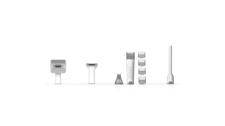 White pet grooming kit components arranged in a row, including trimmer heads, guide combs, a handheld trimmer, and a long attachment White pet grooming kit components arranged in a row, including trimmer heads, guide combs, a handheld trimmer, and a long attachment